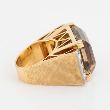 An 18K gold ring set with faceted quartz and old-cut diamons.
