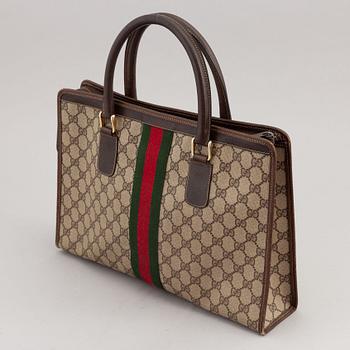 Gucci, a canvas handbag.