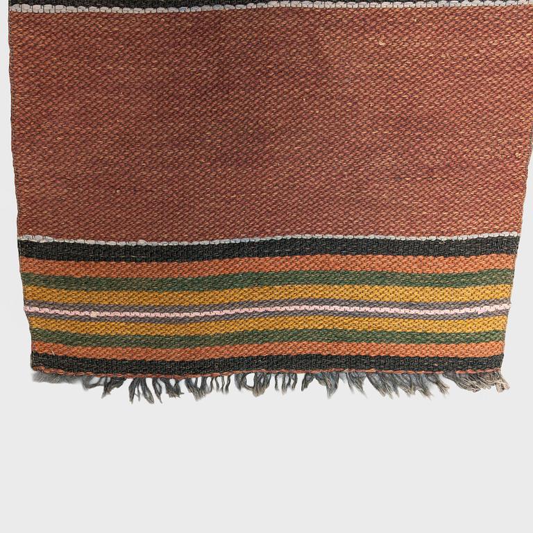 A 1930/1940s rag rug /runner. Circa 550 x 74 cm.