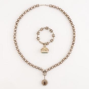 A necklace with a medallion and a bracelet silver, Mexico.