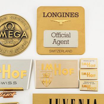 A collection of shop signs and agent plaques from Swiss watchmakers.