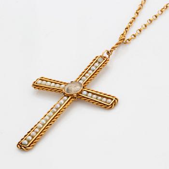 An 18K gold and pearl cross pendant with a gold chain.