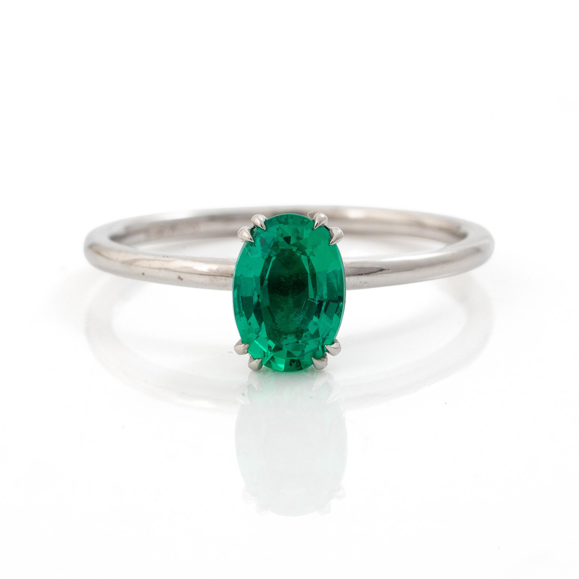 Ring 14K white gold with synthetic emerald and brilliant-cut diamonds.