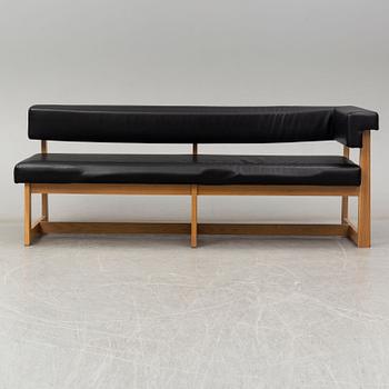 A leather covered oak sofa, 21st Century.
