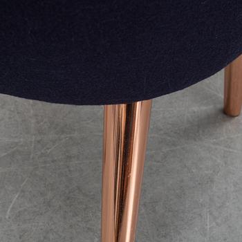 A Tom Dixon "Wingback Dining Chair" from Tom Dixon.