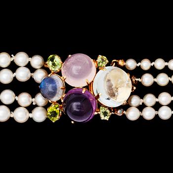 A four strand cultured pearl necklace with cabochon cut amethyst, rose quartz and aquamarine.