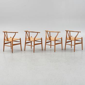 Hans J Wegner, a set of four model CH-24 ”Wishbone” chairs, Carl Hansen & Son, Odense, Denmark.