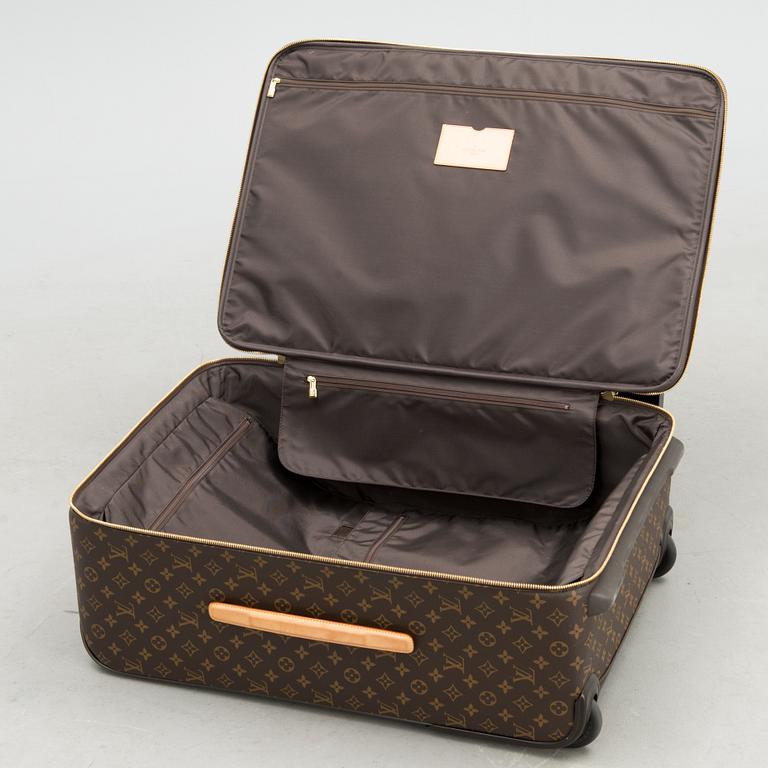 A Monogram Canvas Pégase 65 Suitcase with a Protective Cover.
