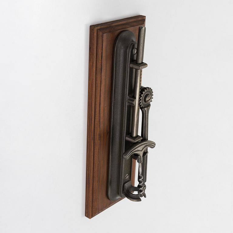 A 21st century French wall-mounted bottle opener.