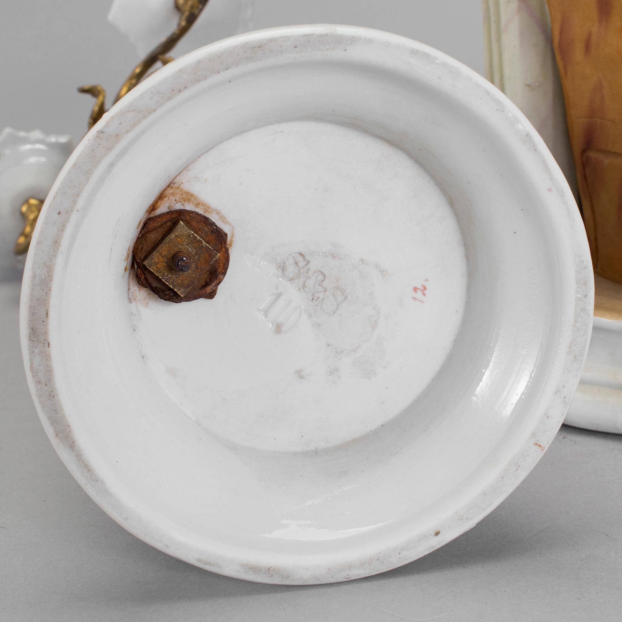 A late 18th century porcelain and biscuit toilette mirror and pair of candelabrar.