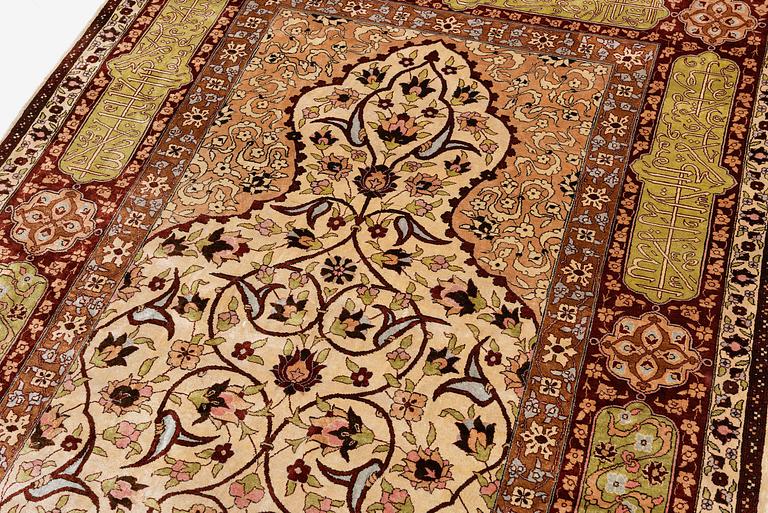 A semi-antique Turkish silk rug, c. 200 x 130 cm.