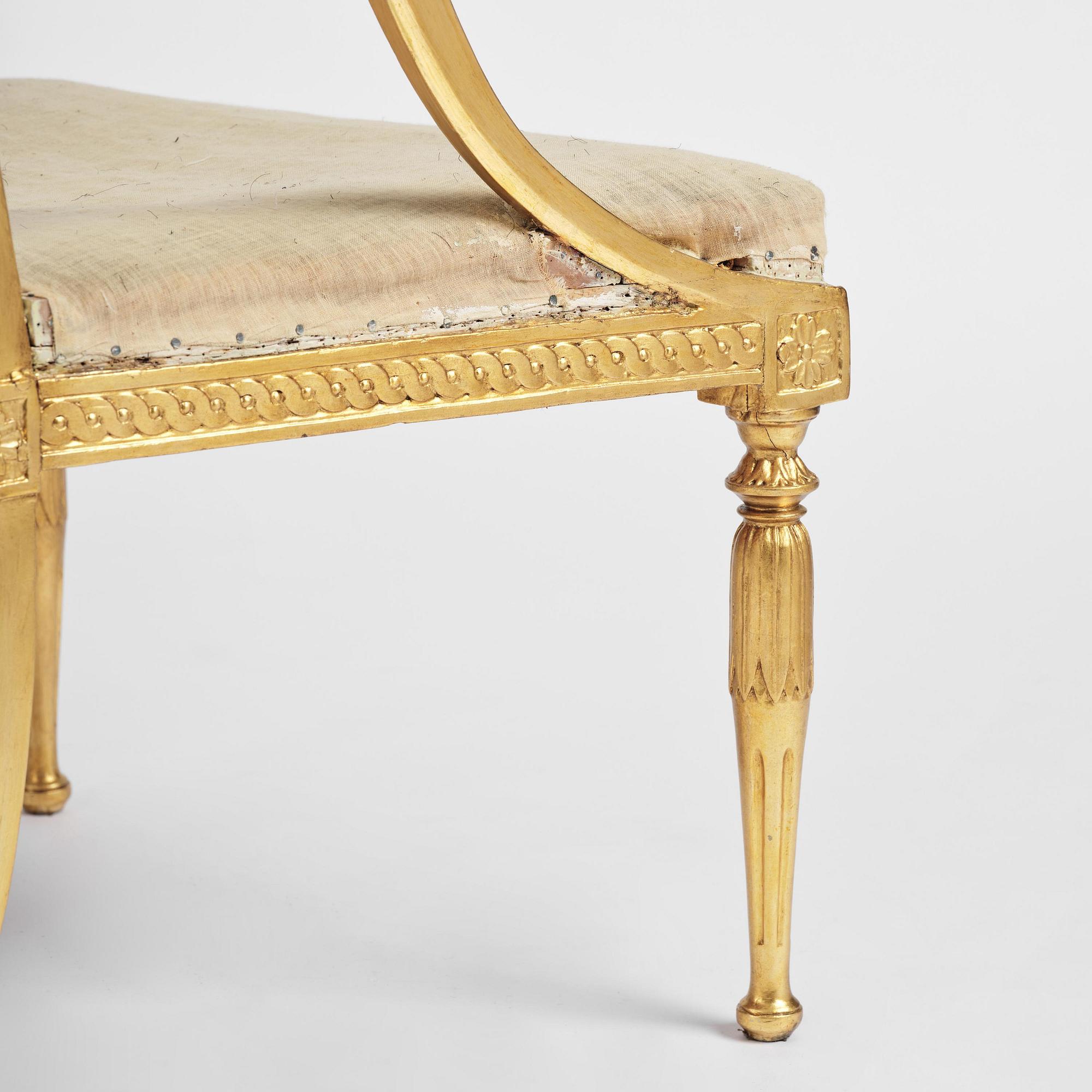 A pair of late Gustavian giltwood open-back armchairs, Stockholm, late 18th century.