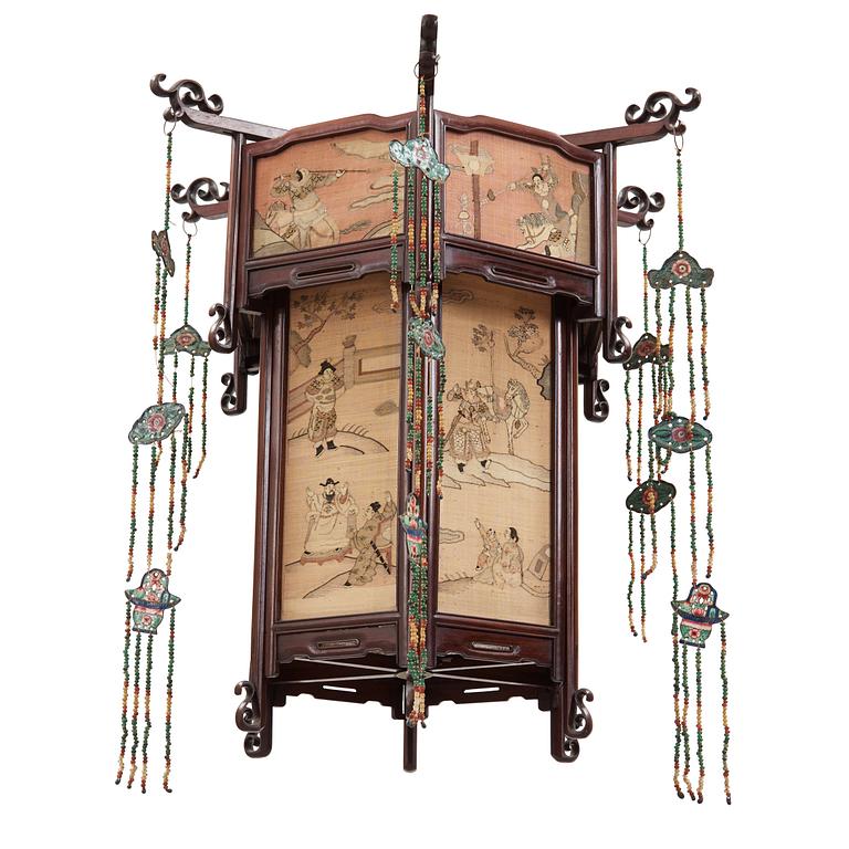 A lantern with panels of kesi woven silk, Qing dynasty, circa 1900.