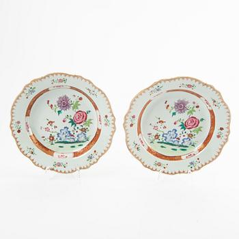 A set of three Chinese famille rose dinner plates, Qing dynasty, 18th Century. (2+1).