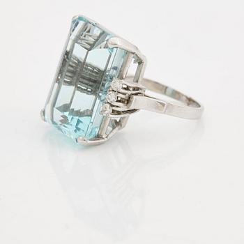 A emerald cut aquamarine and brilliant cut diamond ring.