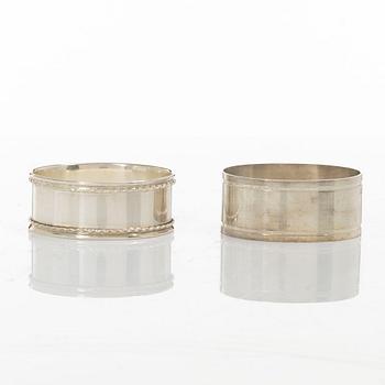 A pair of beakers, two napkin rings, and 17 pieces of cutlery, silver.