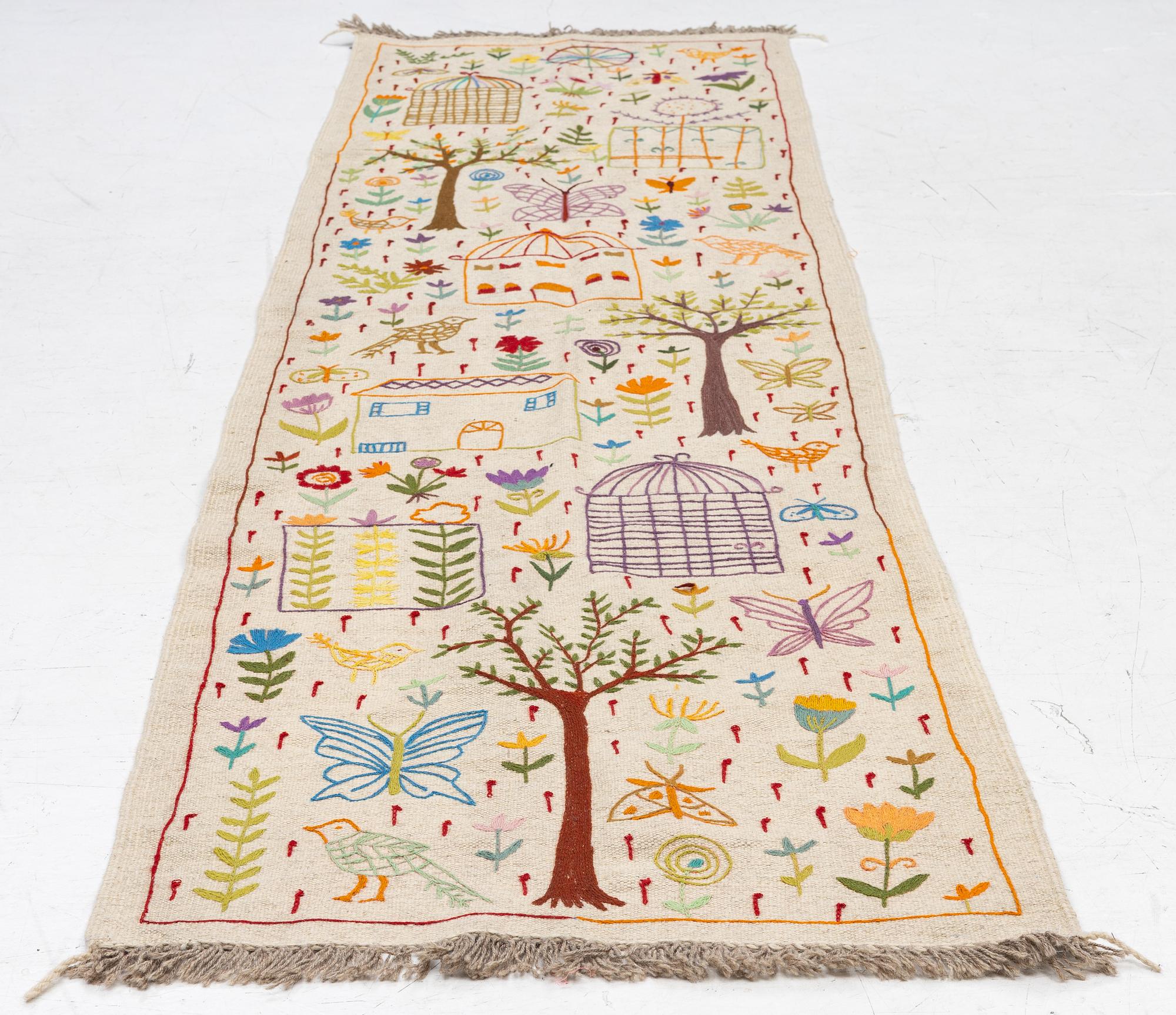 A hand-embroidered kilim runner, c. 300 x 80 cm.