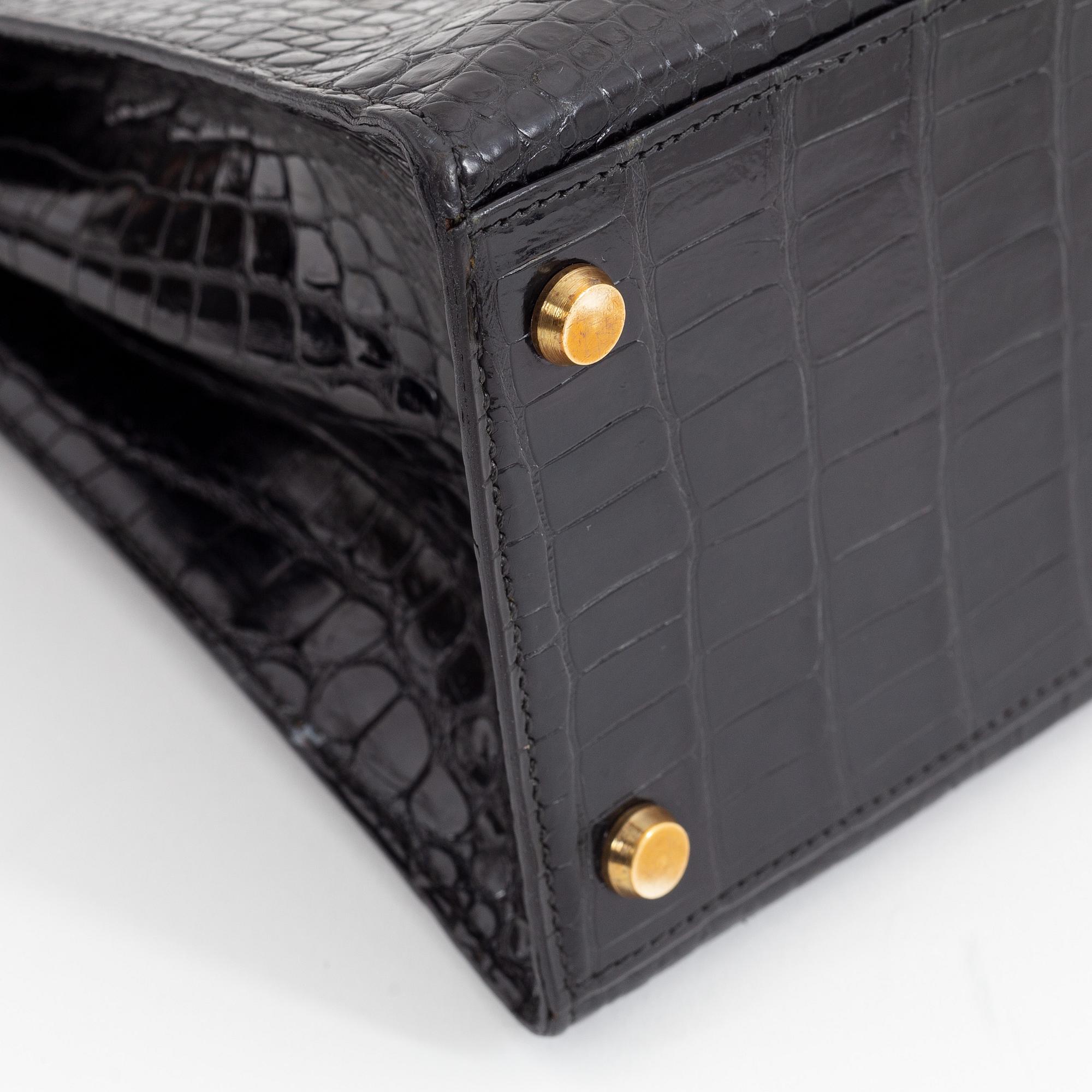 1962 black alligator 'Kelly' handbag by Hermès.