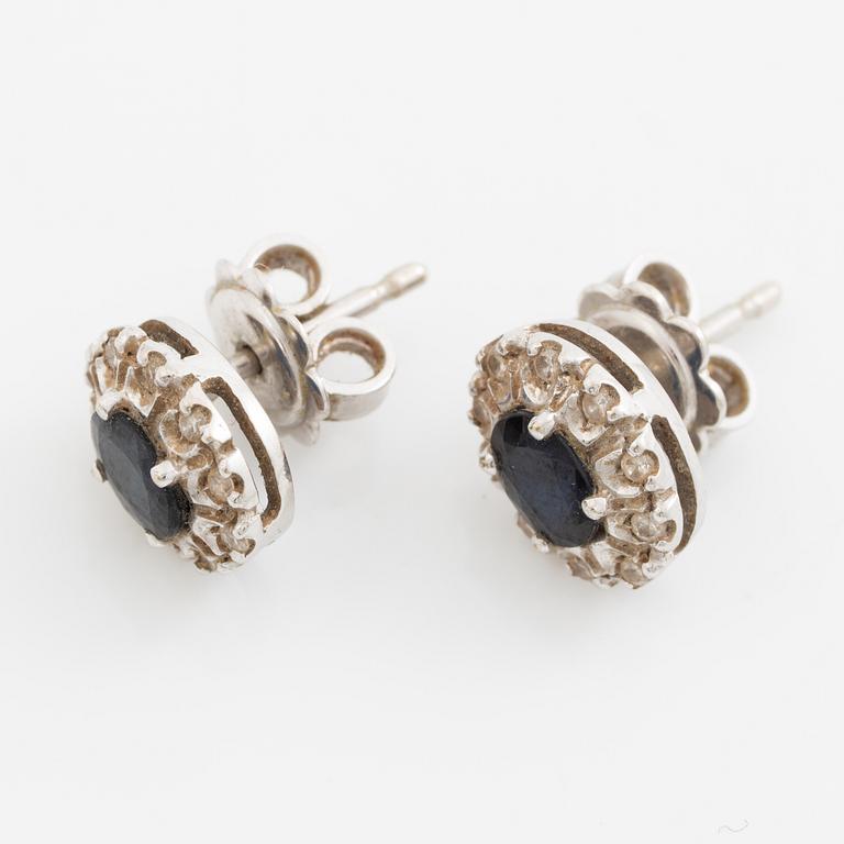 Earrings, a pair of 18K white gold set with dark sapphires and small brilliant-cut diamonds.