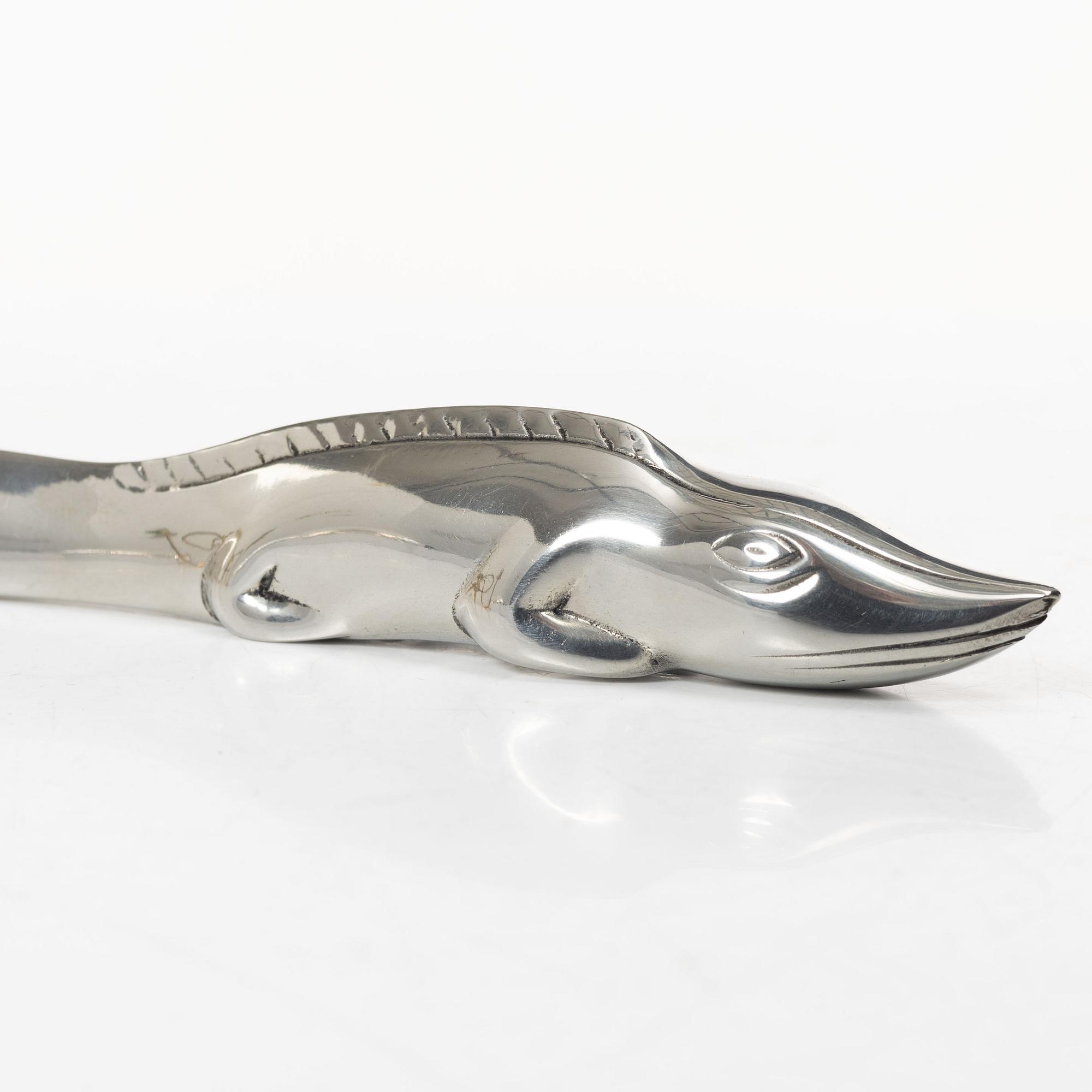 Firma Svenskt Tenn, Candelabrum, 'Vänskapsknuten', and paper knife, 'Alligator'.