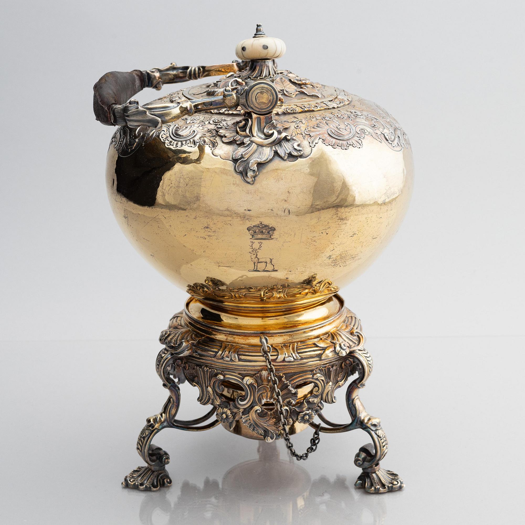 An English silver-gilt teapot with stand and burner, mark of Richard Sibley I, London 1825.