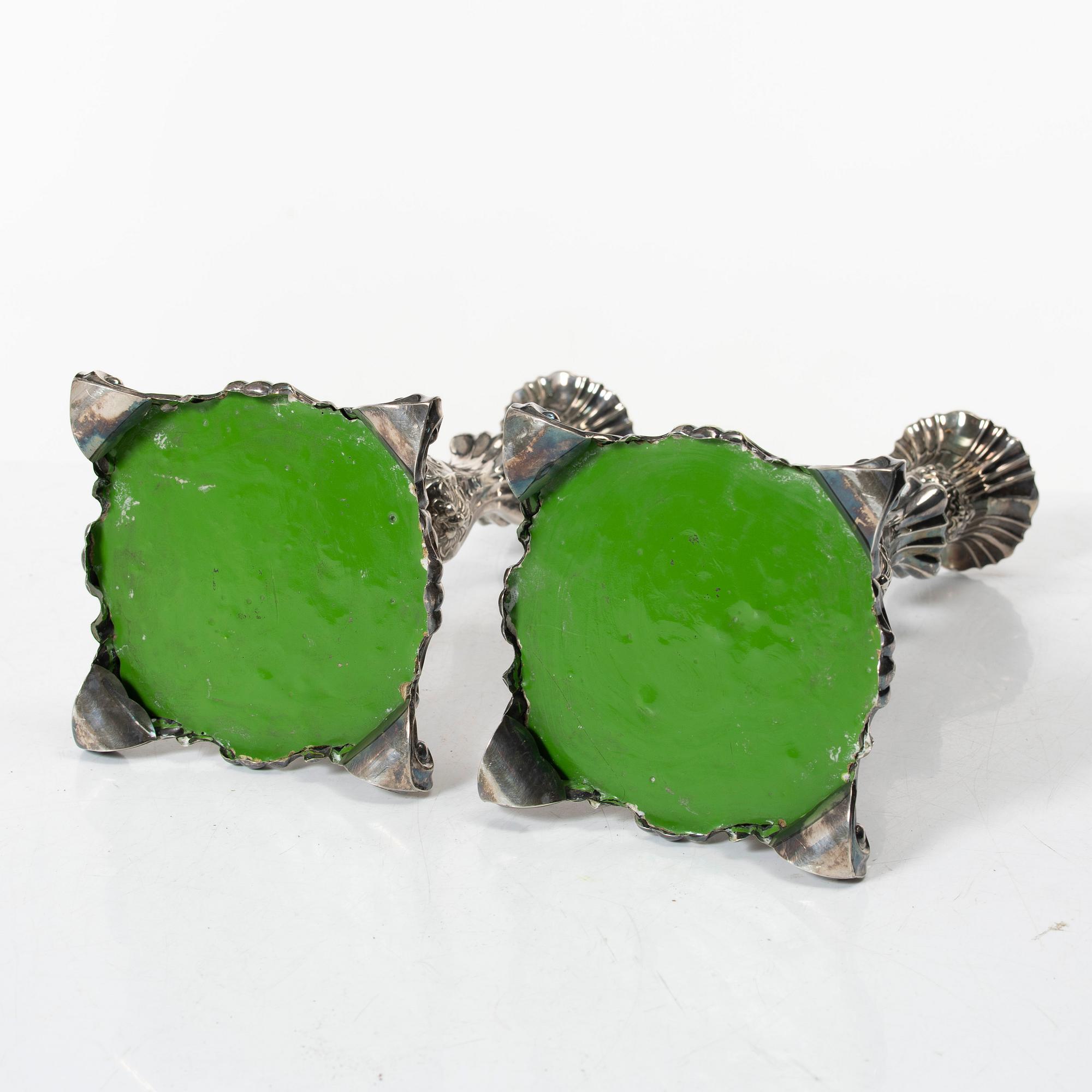 A pair of rococo-style silver candle sticks, early 20th century.