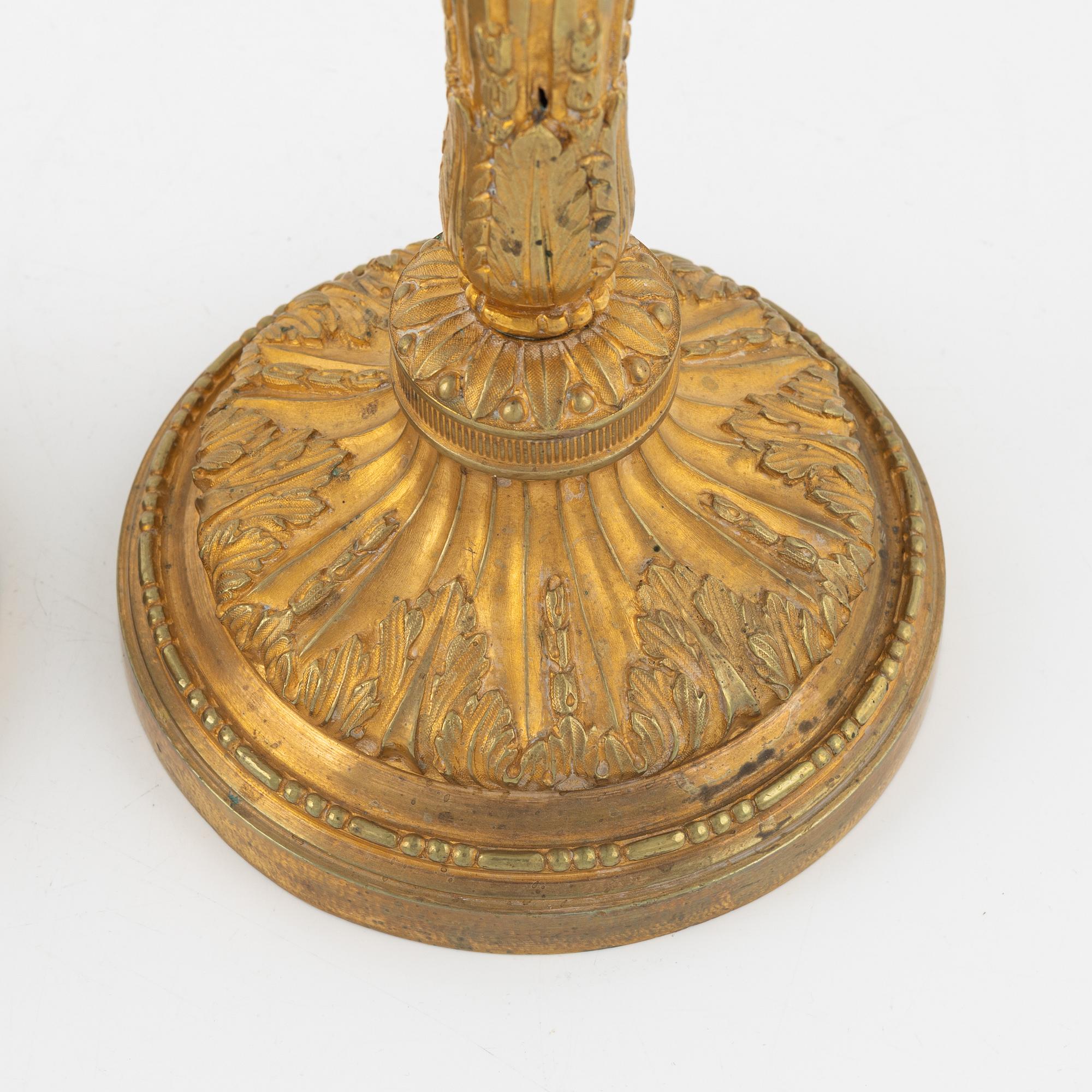 A pair of bronze candle sticks, 20th Century.