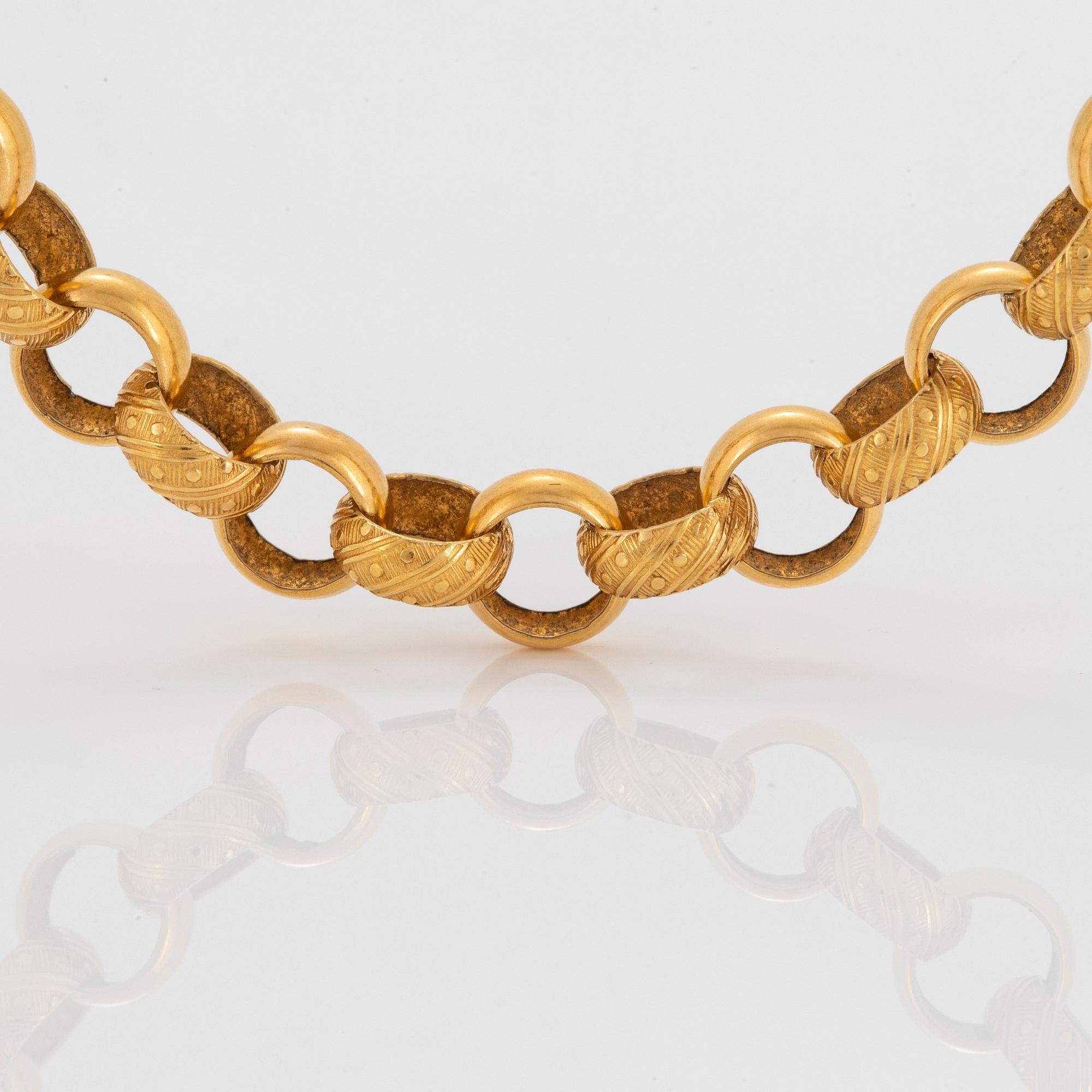 Collier 18K guld med gröna stenar.