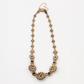 Garniture, two rings, brooch, two necklaces, and two pairs of earrings, armlet, garnets.