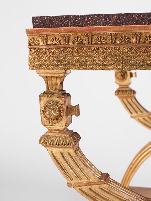 An Empire giltwood and 'Blyberg' porphyry console in the manner of J. Frisk, Stockholm early 19th century.