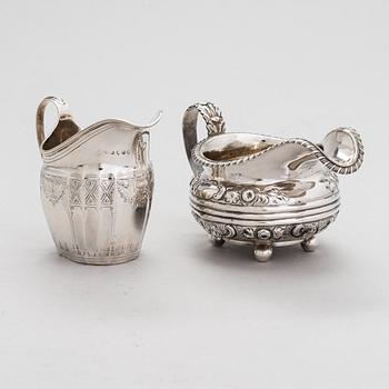 Two sterling silver milk jugs, London 1794 och 1828.