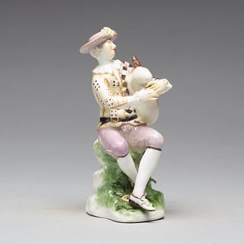 A porcelain figure of a bagpiper, 'Meissen mark'.