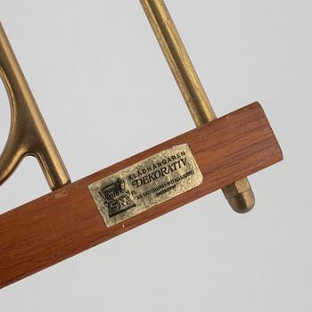 A pair of 'Dekorativ' coat hangers, Skoglunds metallgjuteri, Anderstorp, mid 20th Century.