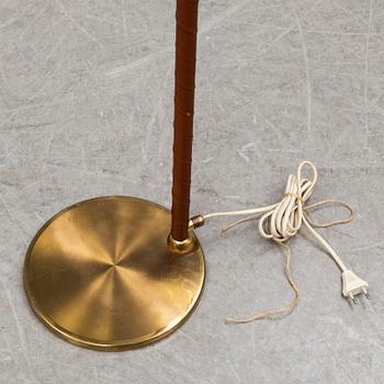 a brass and leather floor lamp from the second half of the 20th century.