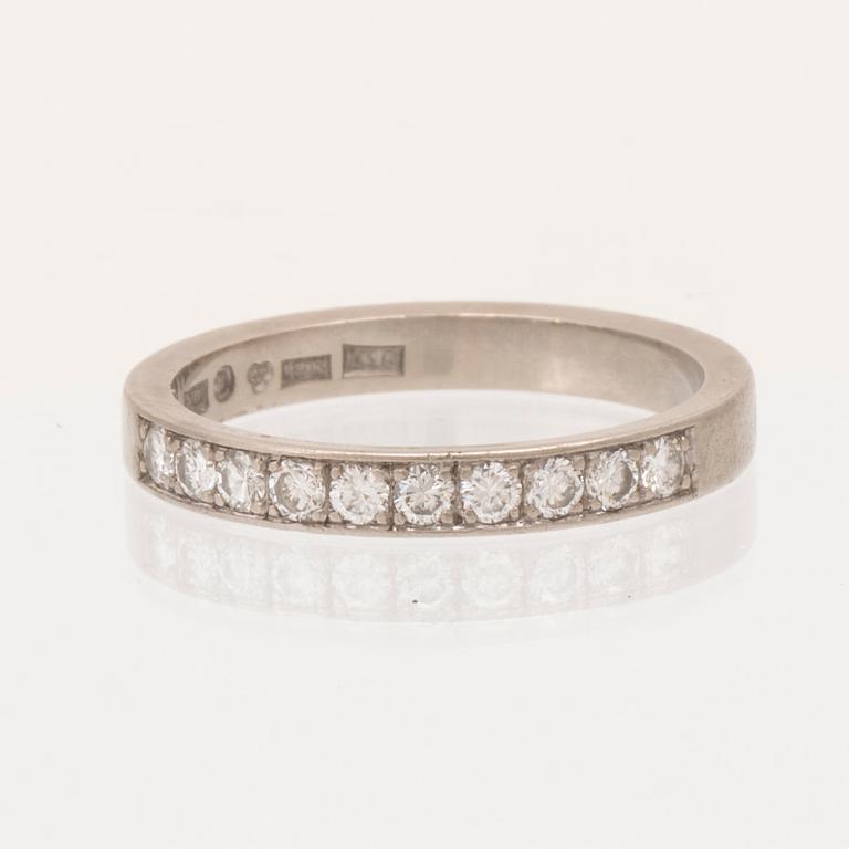 An 18K white gold half eternity ring set with round brilliant-cut diamonds.