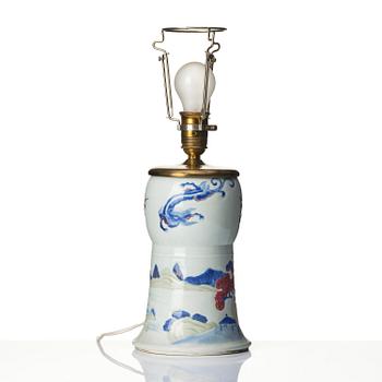A celadon, copper-red and underglaze blue carved beaker vase, Qing dynasty, Kangxi mark and of the period (1662-1722).