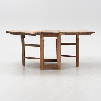 A pine gateleg table, 19th Century.