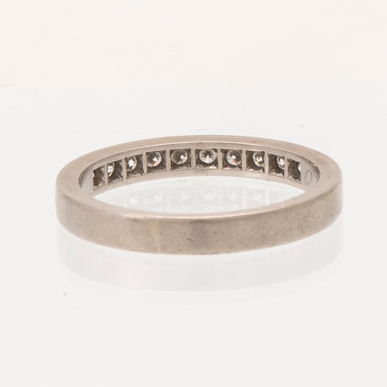 An 18K white gold half eternity ring set with round brilliant-cut diamonds.