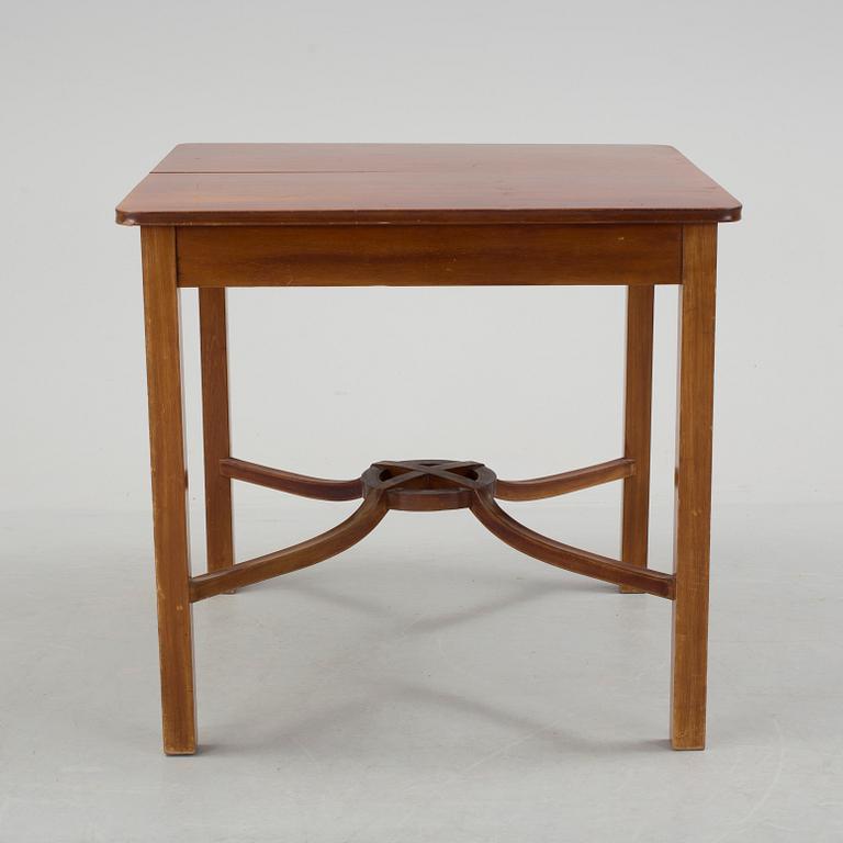 A mid 20th century mahogany veneered table from Nordiska Kompaniet (NK).