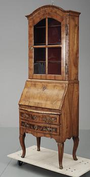 A Rococo walnut writing cupboard.
