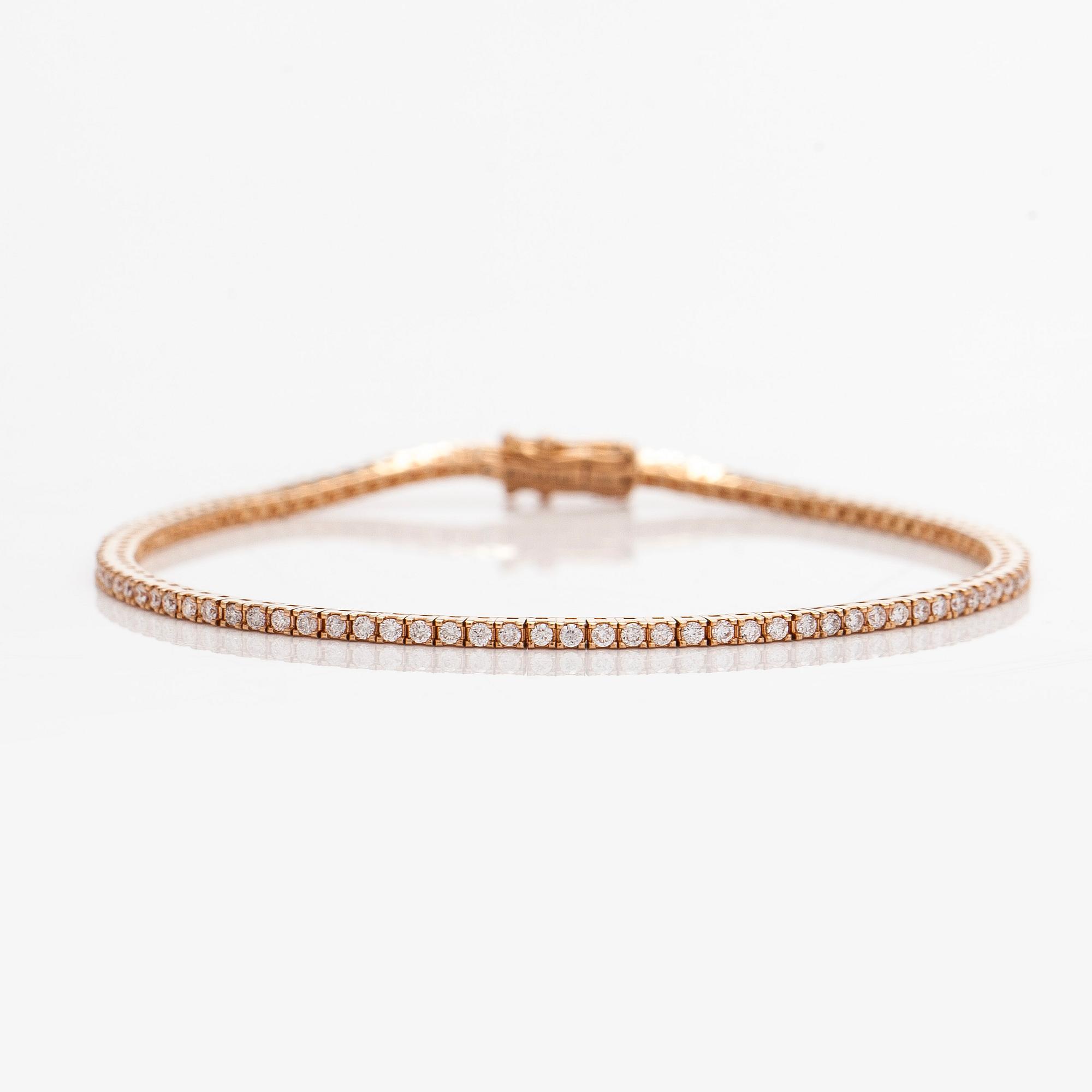 An 18K rose gold tennis bracelet with brilliant cut diamonds.