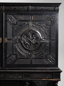 A Louis XIV and Louis XIV-style carved ebony, ivory and tortoiseshell-inlaid cabinet on stand, 17th and 19th century.