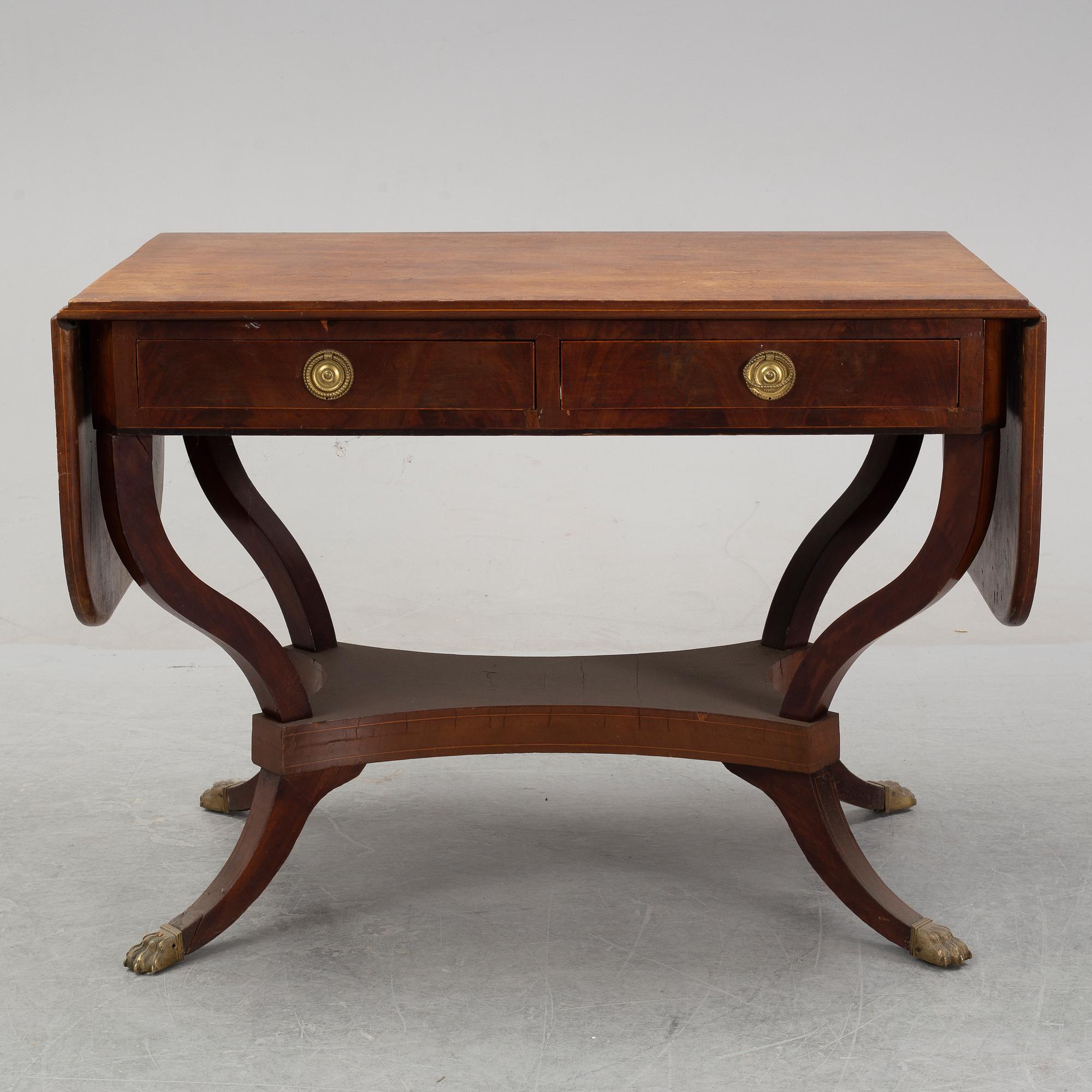 An Empire style mahogany  center table from around the year 1900.