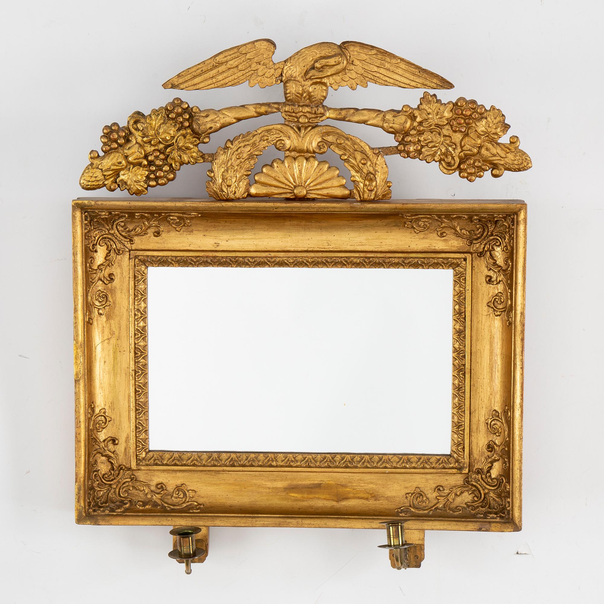 A first half of the 19th century mirror wall sconce.