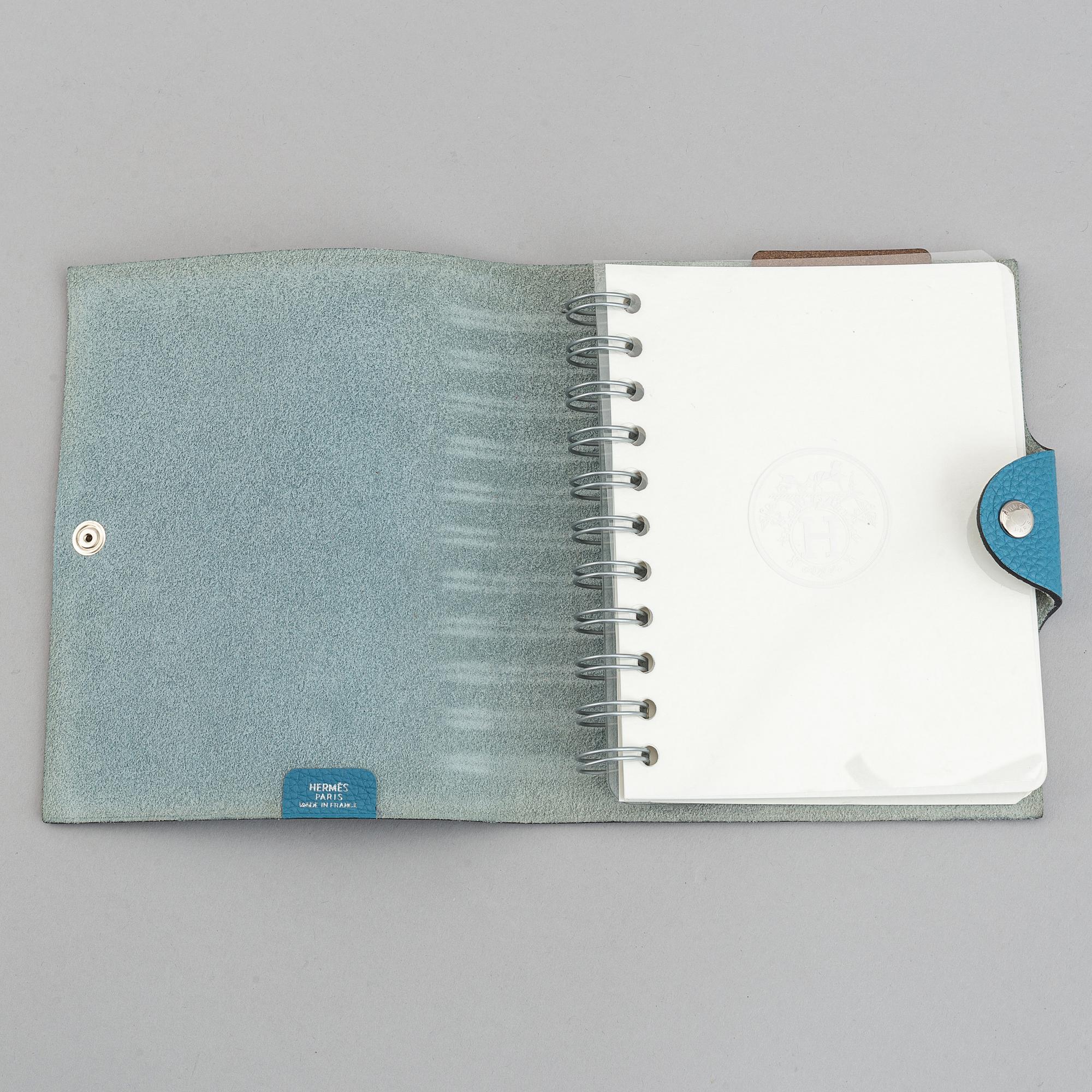 Hermès, a blue leather notebook with two scripple pads.