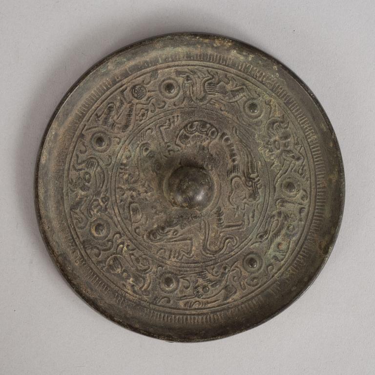A bronze mirror, Han dynasty (206 B.C - 220 A.D).