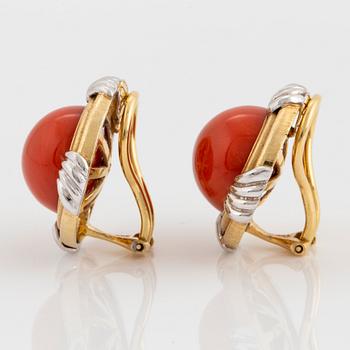 A pair of 18K gold and white gold earrings set with coral.