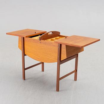 A mid 20th century teak sewing table.