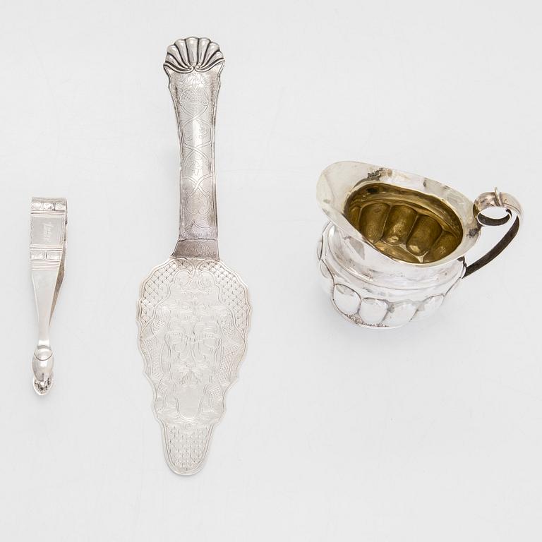 Cream jug, cake server, and sugar tongs in silver, Finland from latter part of the 18th century to 1854.