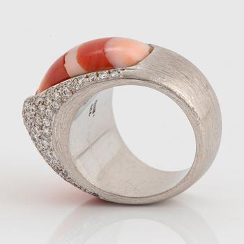 A Paul Binder ring in 18K white gold set with coral and round brillliant-cut diamonds.